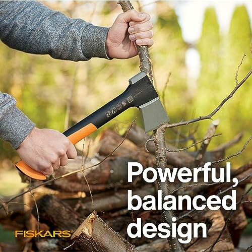 Person using an axe to cut branches, with text 'Powerful, balanced design'.