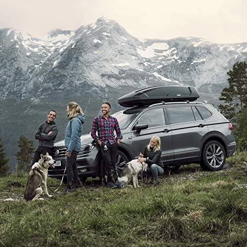 Group with dogs and SUV in mountain scenery