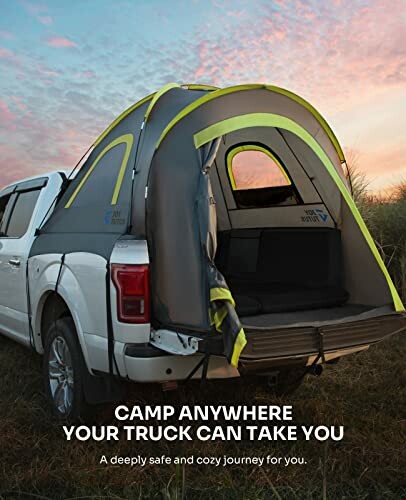 Truck with a tent set up in the bed at sunset.